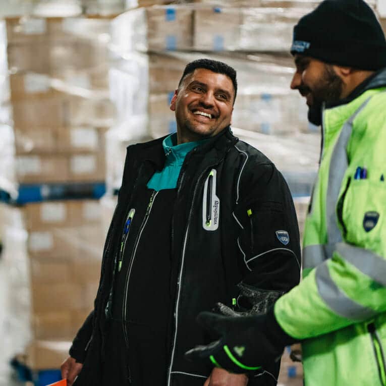 Two man smiling while working at Klondike