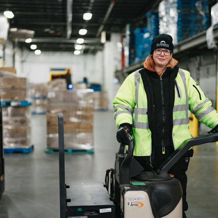 Woman at Klondike operating machinery in the warehouse